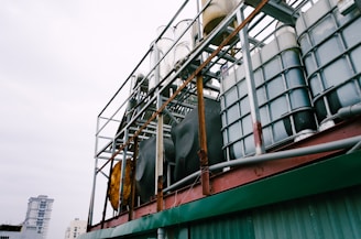 white IBC tanks on green building