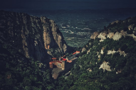 photography of building at mountain valley in Montserrat Spain
