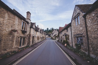concrete road between brick wall buildings