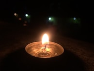 Candles glowing softly beside a microphone at a small worship gathering.