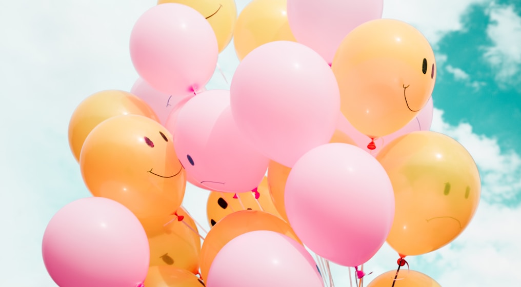 low-angle photo of pink and orange balloons