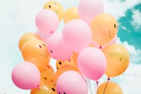 low-angle photo of pink and orange balloons