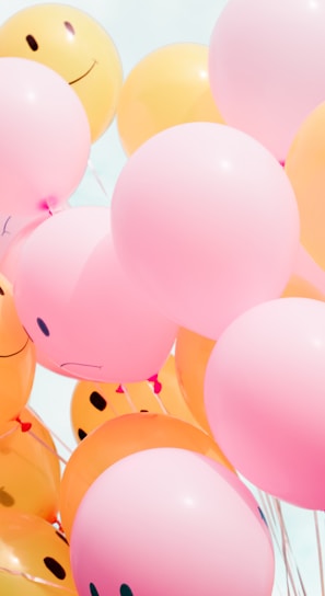 low-angle photo of pink and orange balloons