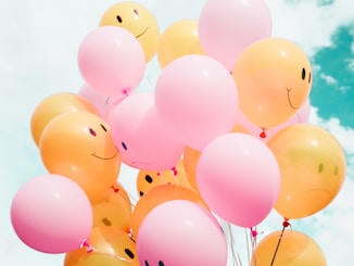 low-angle photo of pink and orange balloons