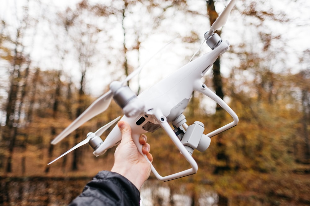 person holding DJI Phantom 4 drone