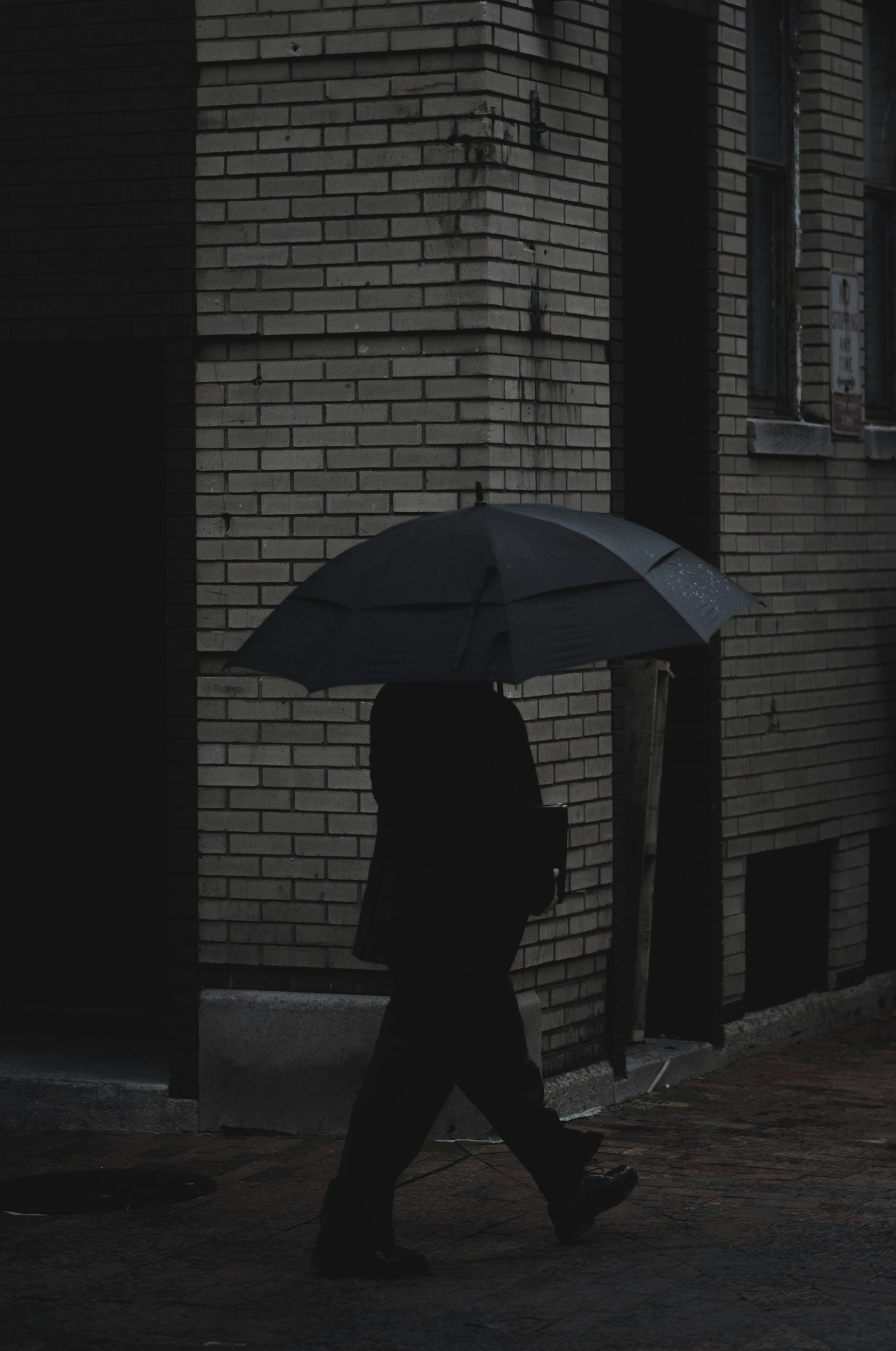 Fujifilm X-Pro2 + Fujifilm XF 56mm F1.2 R sample photo. Person holding umbrella walking photography