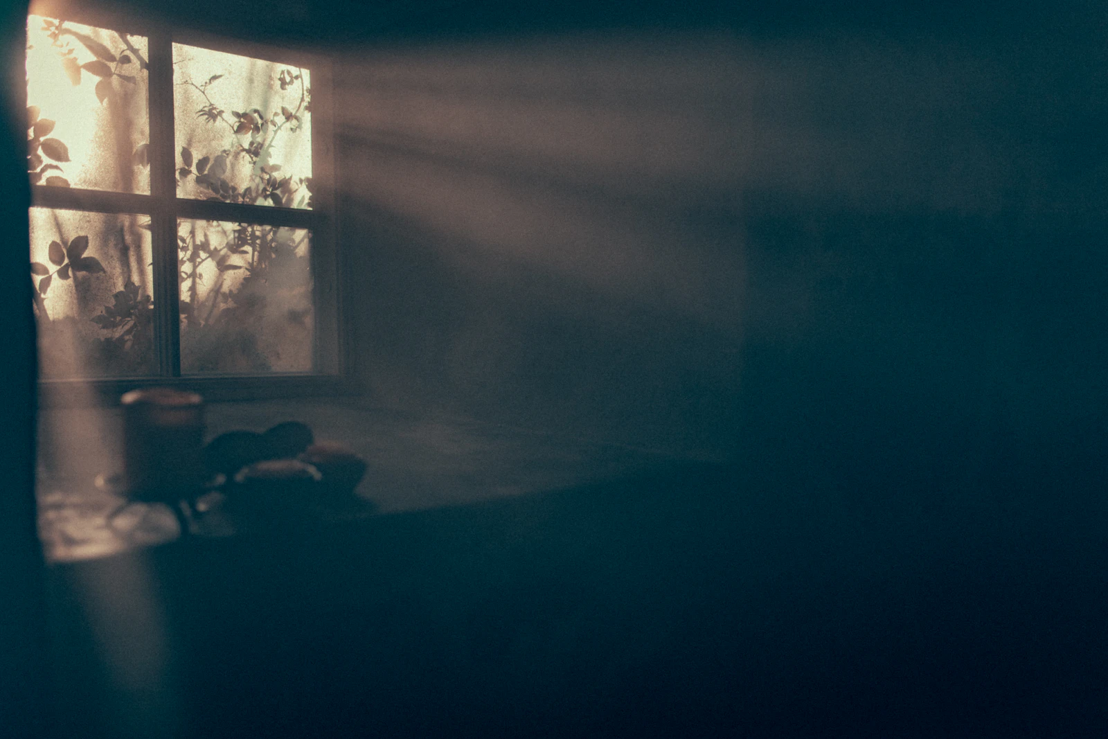 A dim room with a single chair and a streak of window light