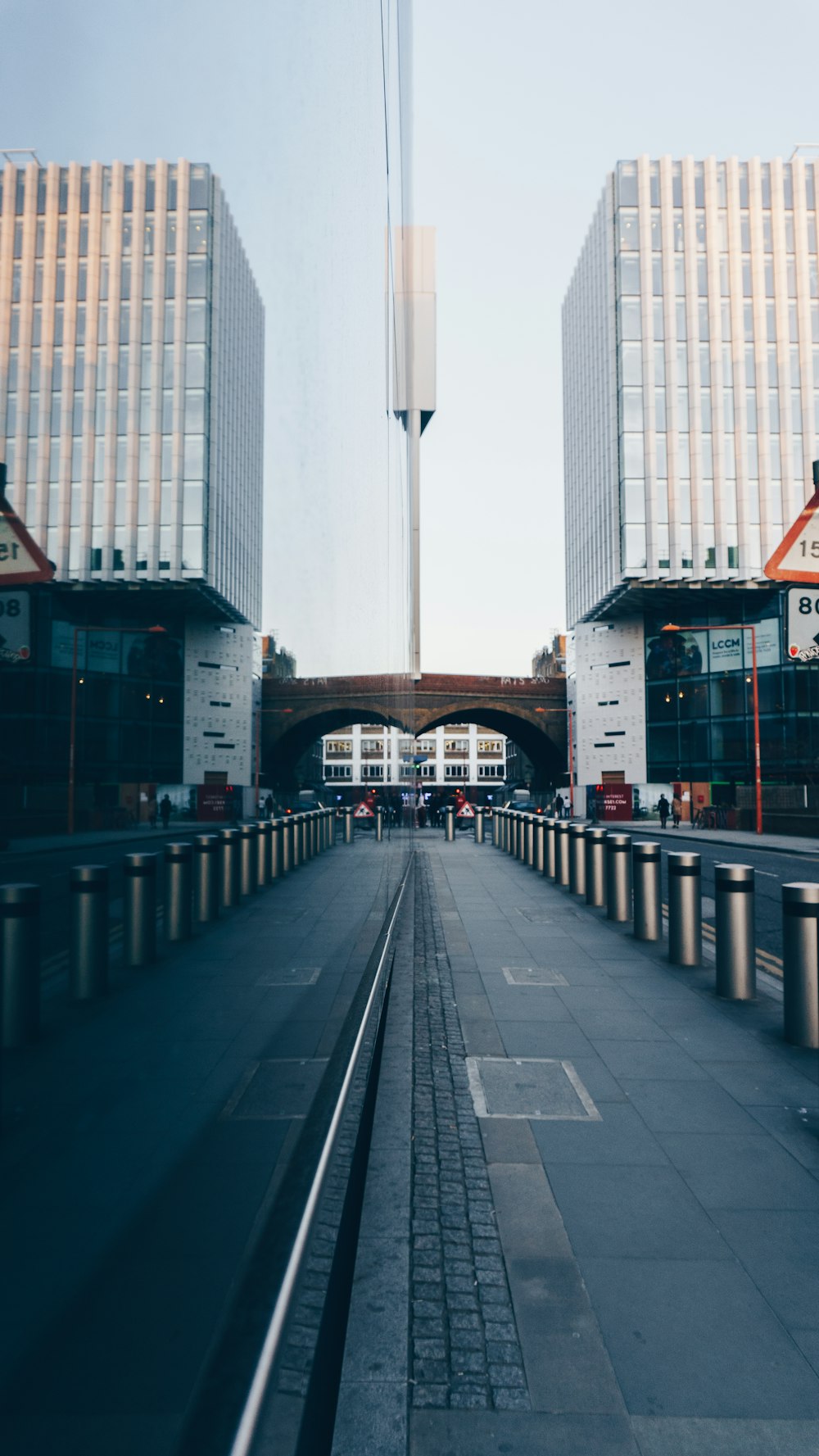 wide road towards building under white sky