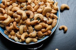 cashew nut lot on blue ceramic bowl