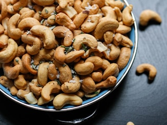 cashew nut lot on blue ceramic bowl