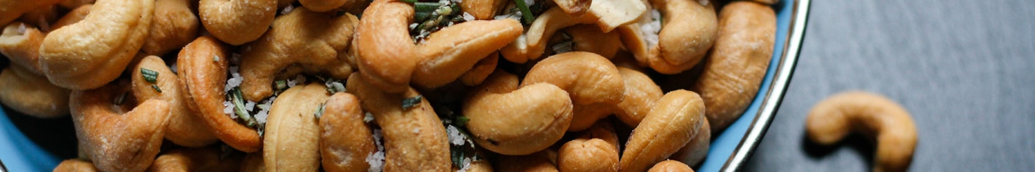 cashew nut lot on blue ceramic bowl