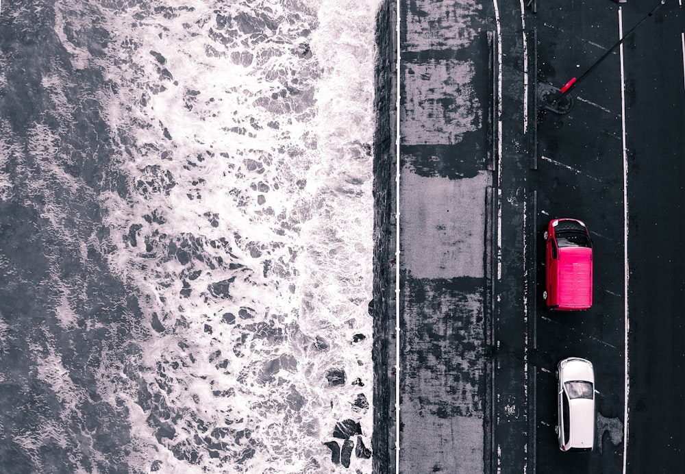 aerial photography of two vehicles near sea