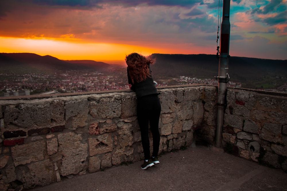 donna che indossa leggings neri durante il tramonto