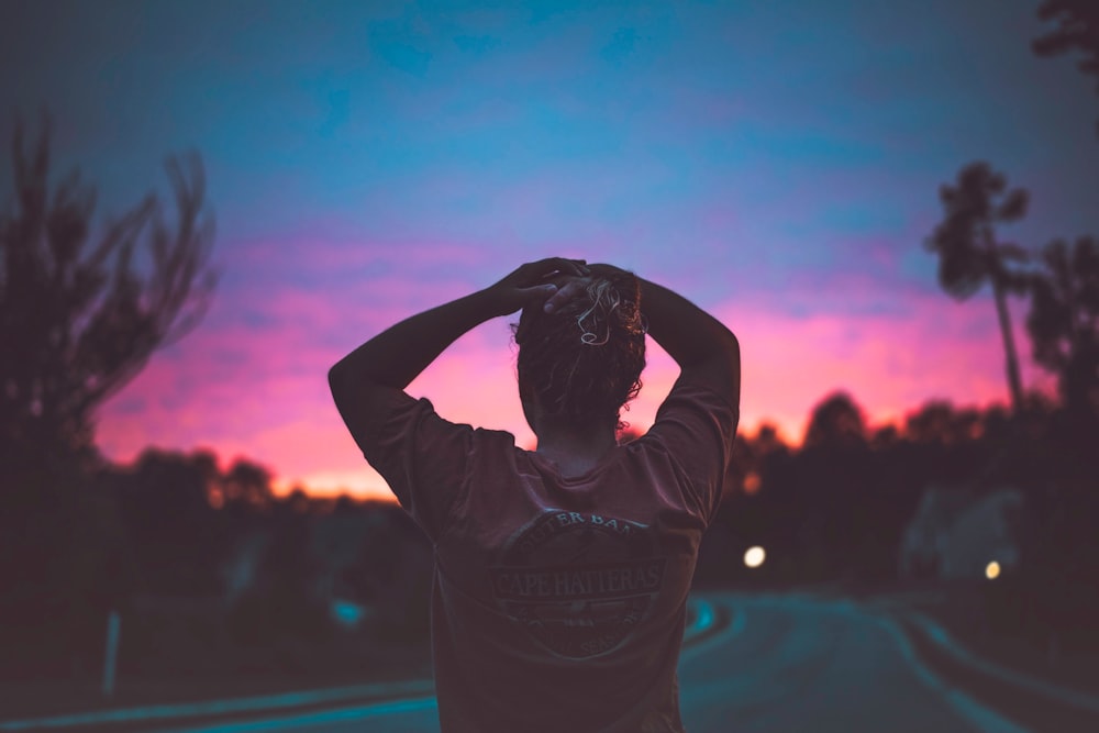 silhouette photography of woman holding her head