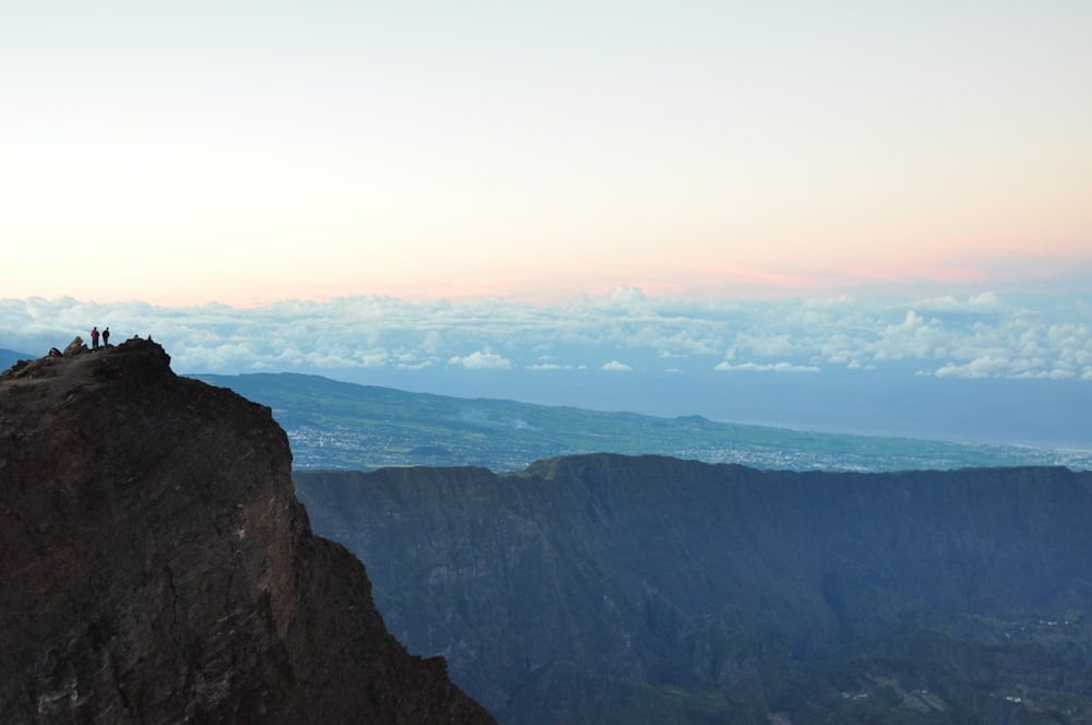 person standing on cliff during daytime