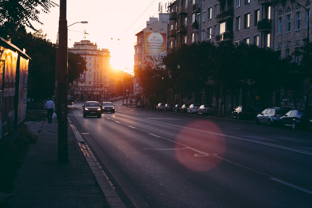 two vehicle on road during sun rise