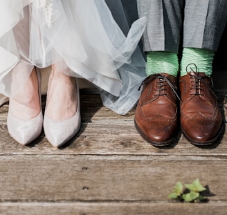 two people standing on brown wooden floor