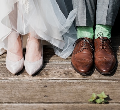 two people standing on brown wooden floor