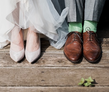 two people standing on brown wooden floor