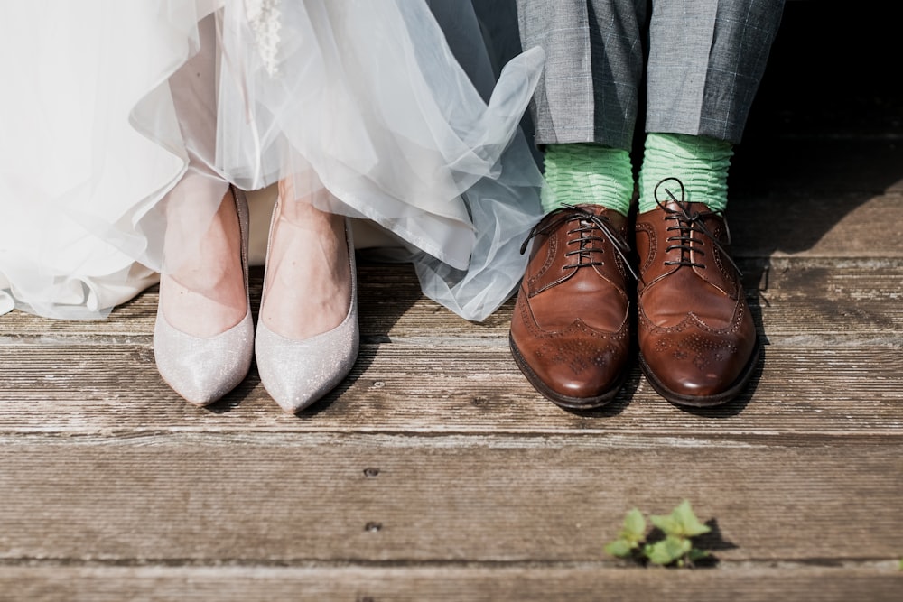 two people standing on brown wooden floor