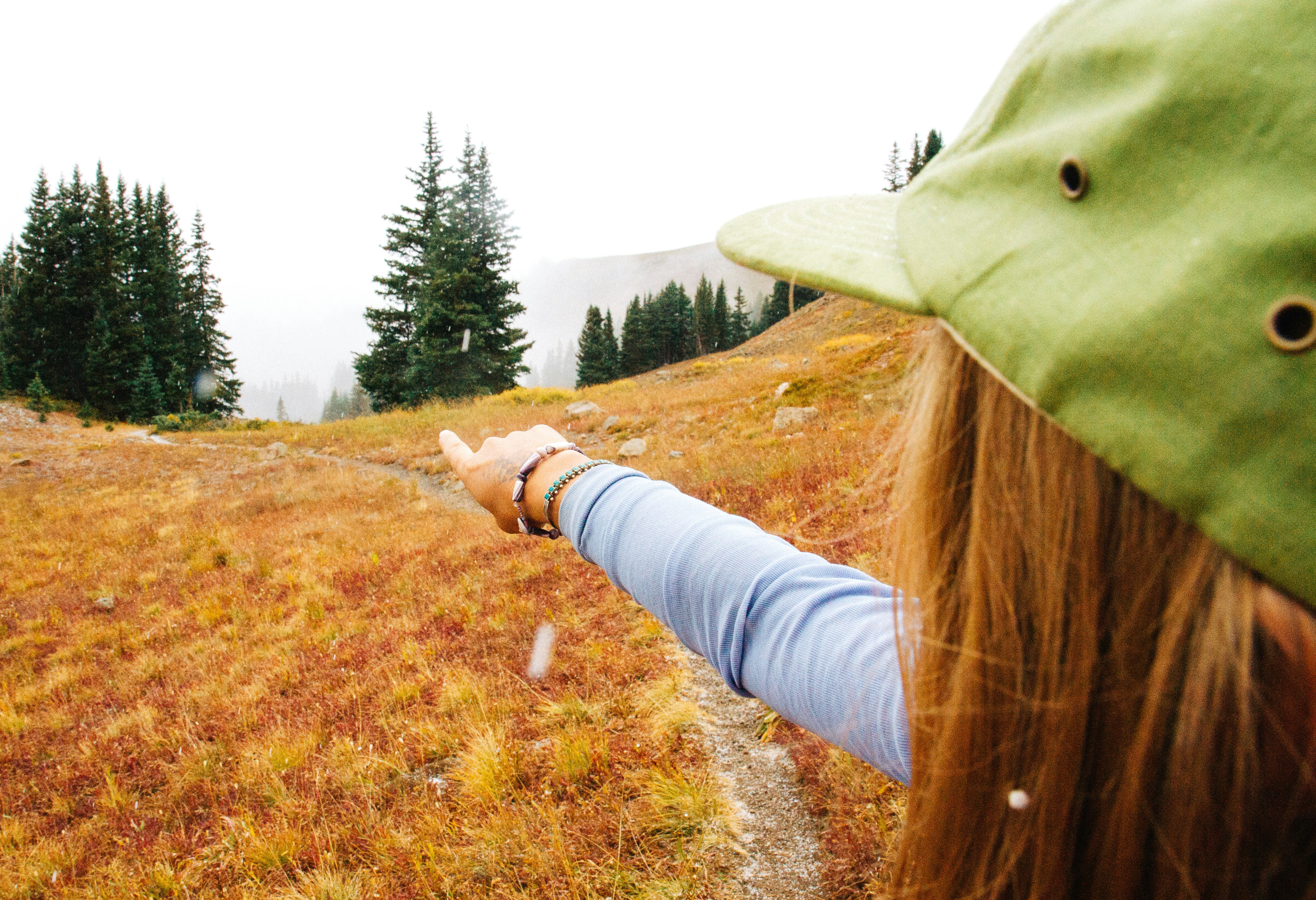 woman pointing green tree, 