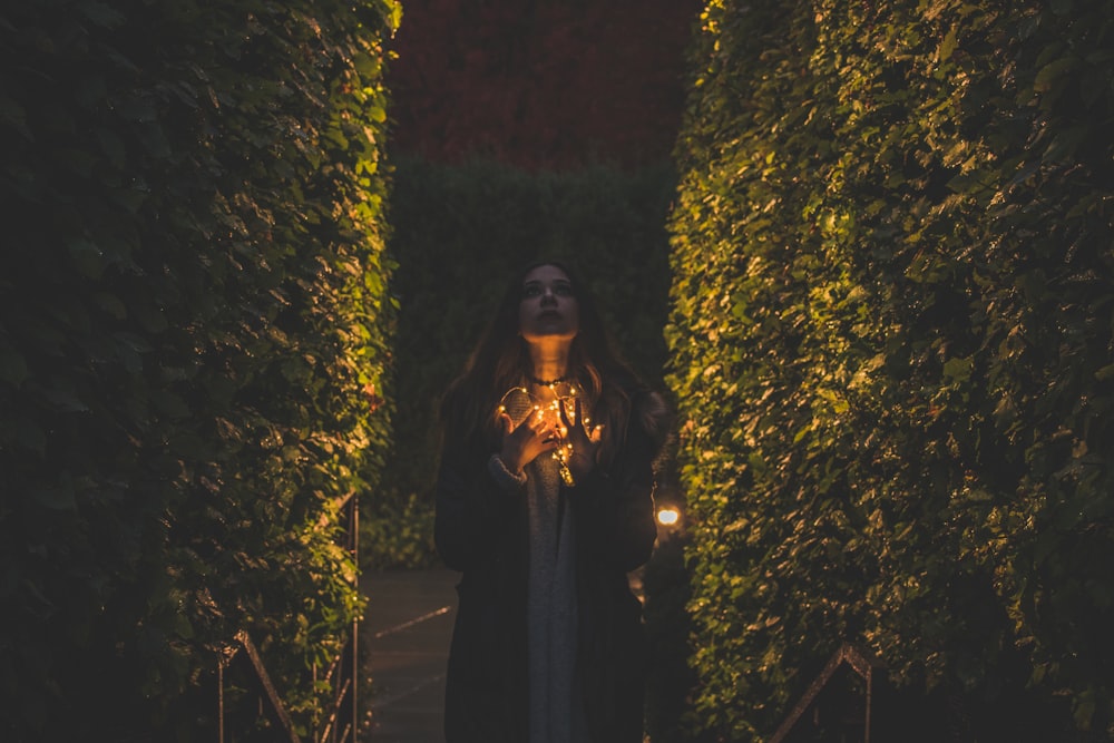 woman beside a plants looking up