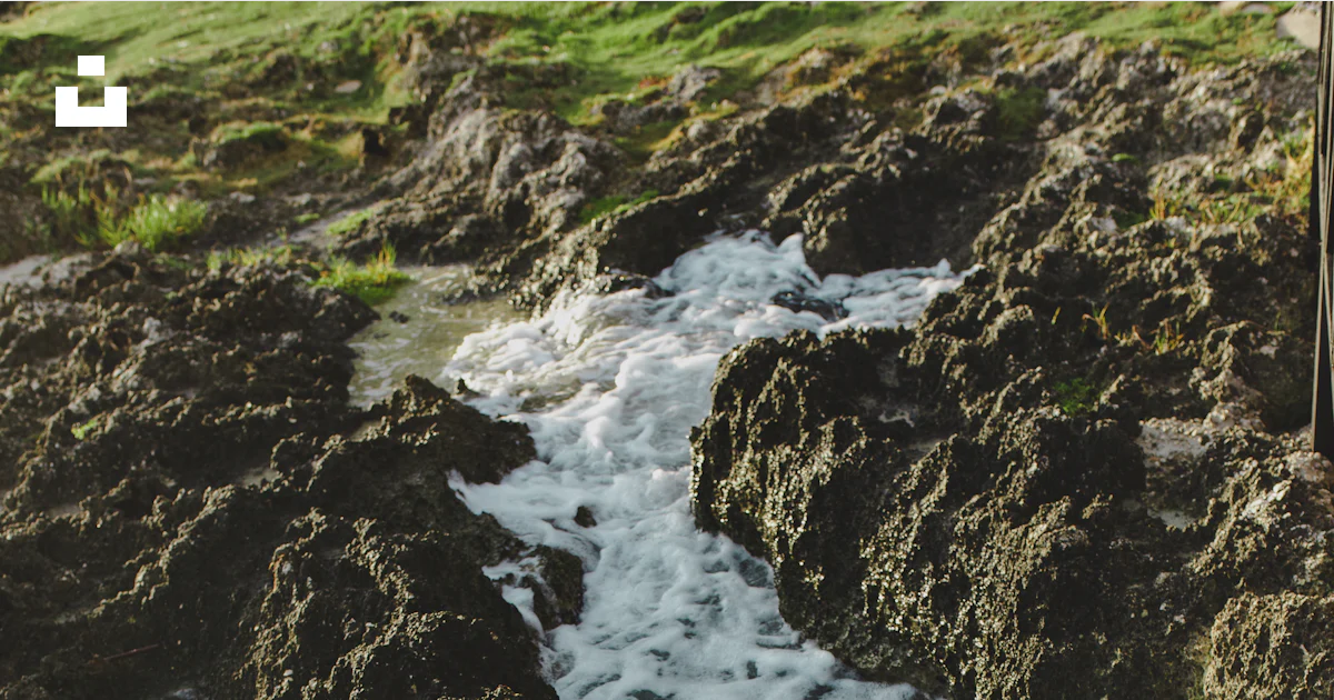 Stream Between Two Rocks A stream of water running between two large rocks photo – Free Grey ...