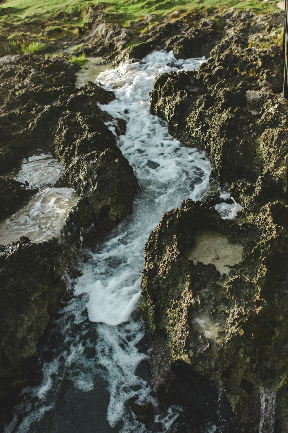 a stream of water running between two large rocks