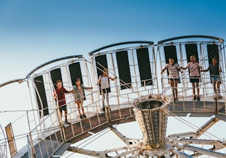 Children excitedly stepping onto the rotating platform, ready for their turn to be photographed.