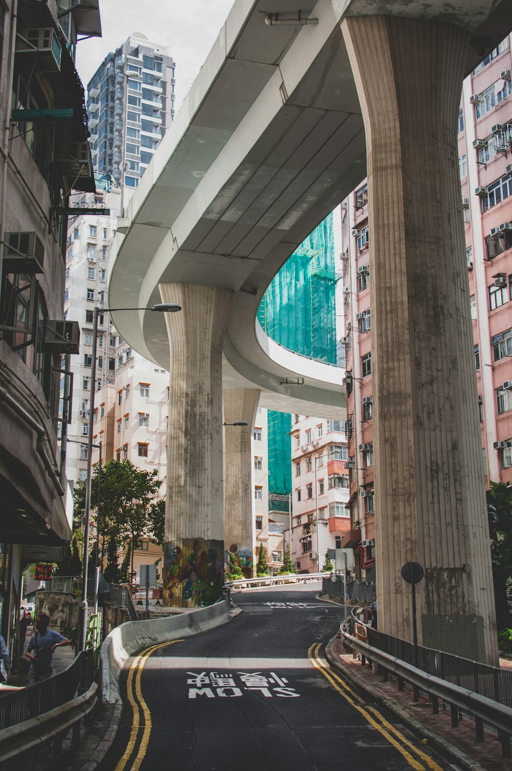 empty street with kanji text in between of high rise buildings