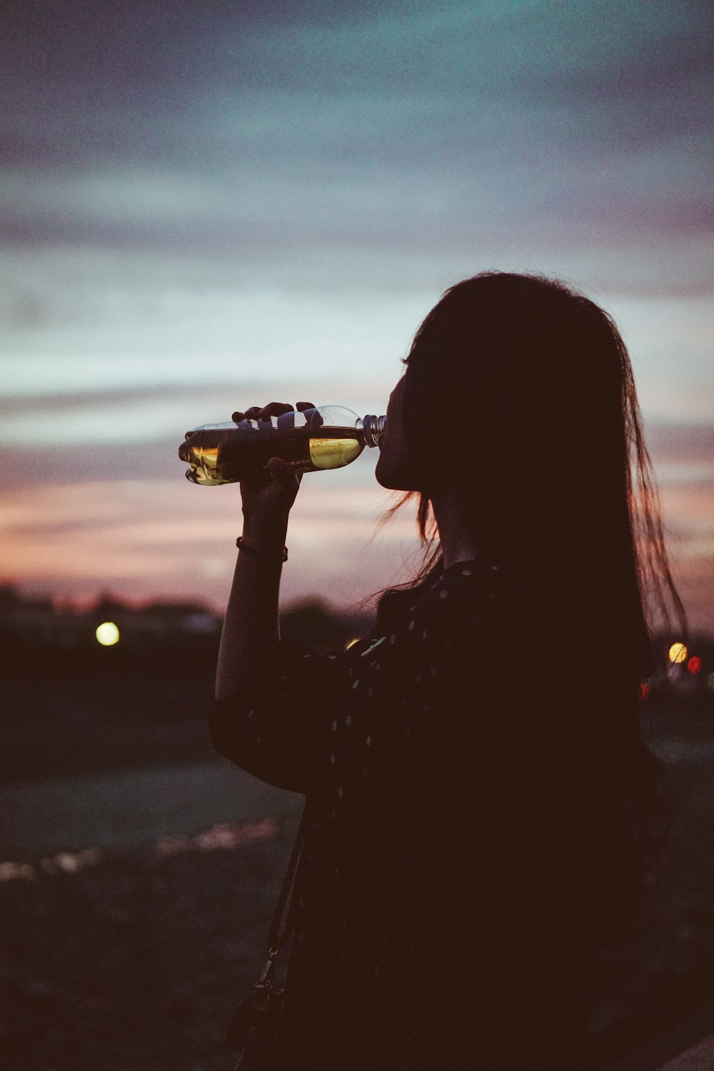 Foto de la silueta de la mujer bebiendo agua