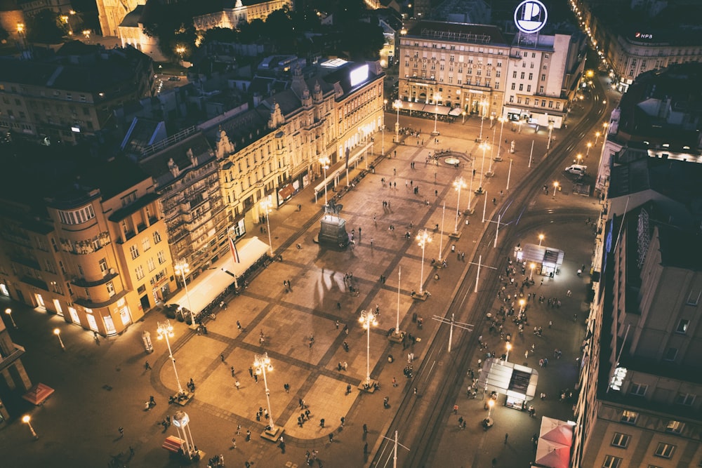 people walking near lighted buildings