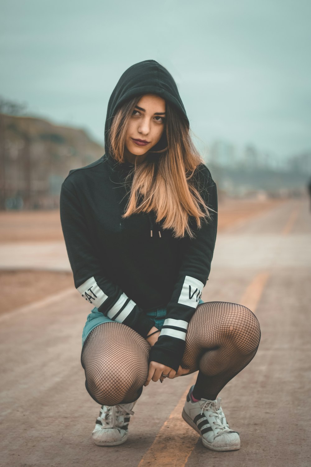 woman crouch on road