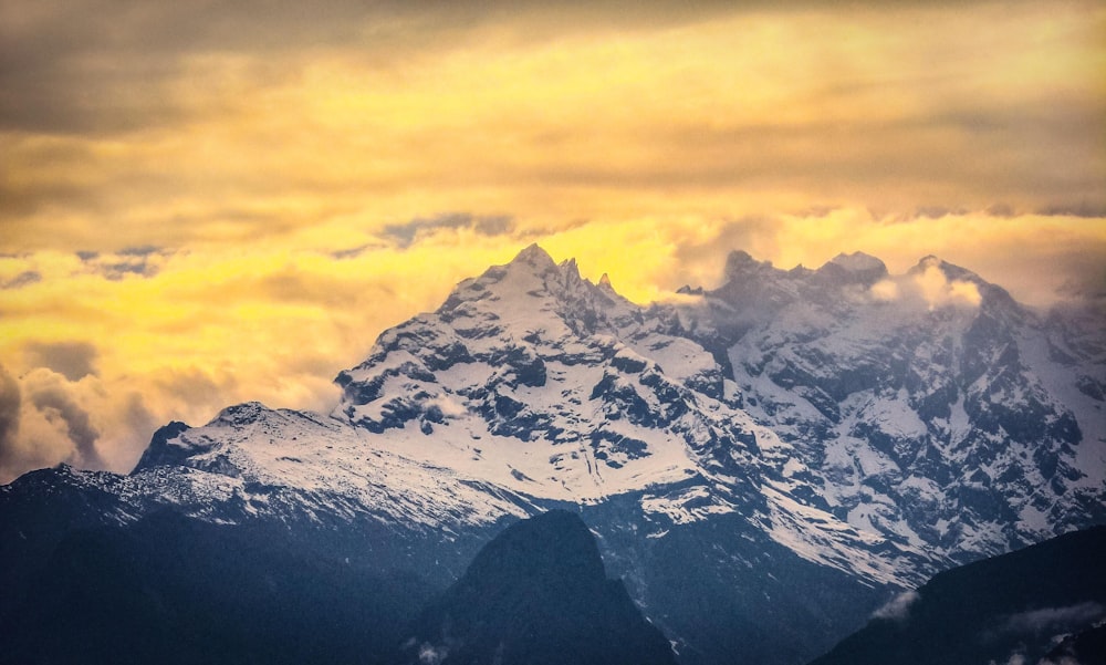 snow-capped mountain during golden hour aerial photo