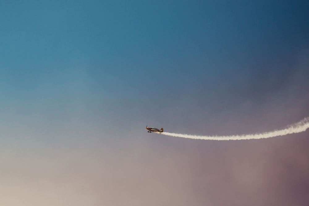 black plane under blue and grey sky