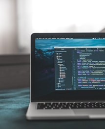 laptop computer showing code building website with react
