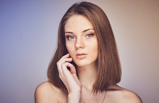 woman with her hand on cheek