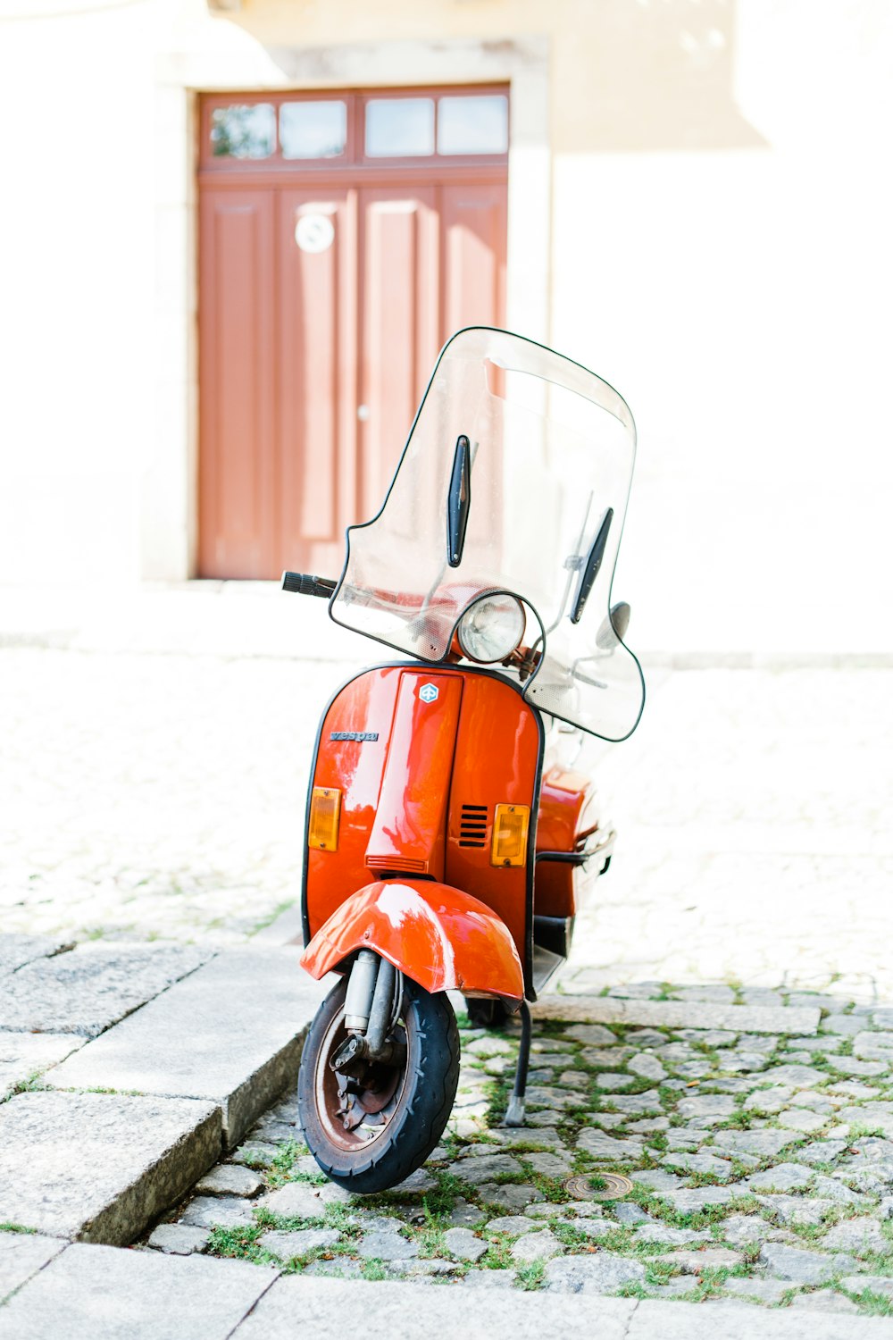 orange motor scooter outdoor during daytime