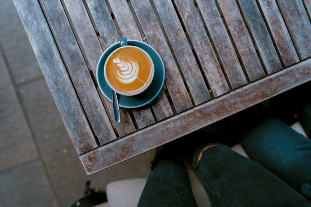 leaf themed coffee in green ceramic cup on saucer