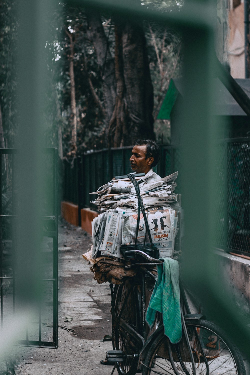 man near on pile of newspapers