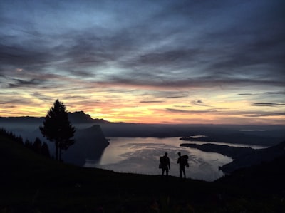 two person walking down on the mountain awesome teams background