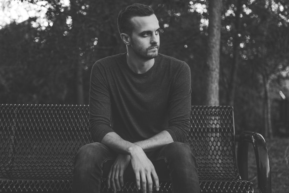 grayscale photography of man wearing long-sleeved shirt