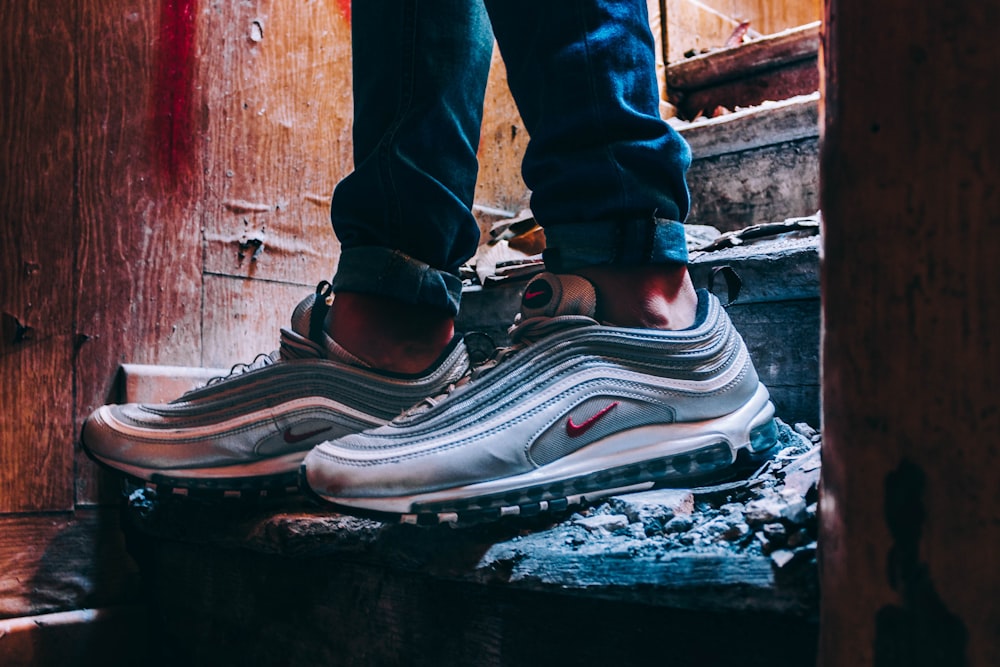 pair of grey Nike Air Max 97's