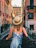 Young woman with a backpack looking excited in front of famous European landmarks.
