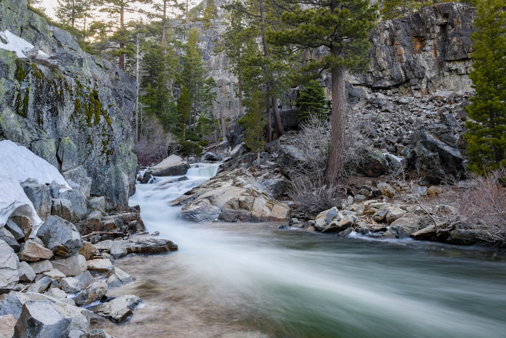 Fotografia em timelapse de rio fluindo entre formações rochosas cinzentas