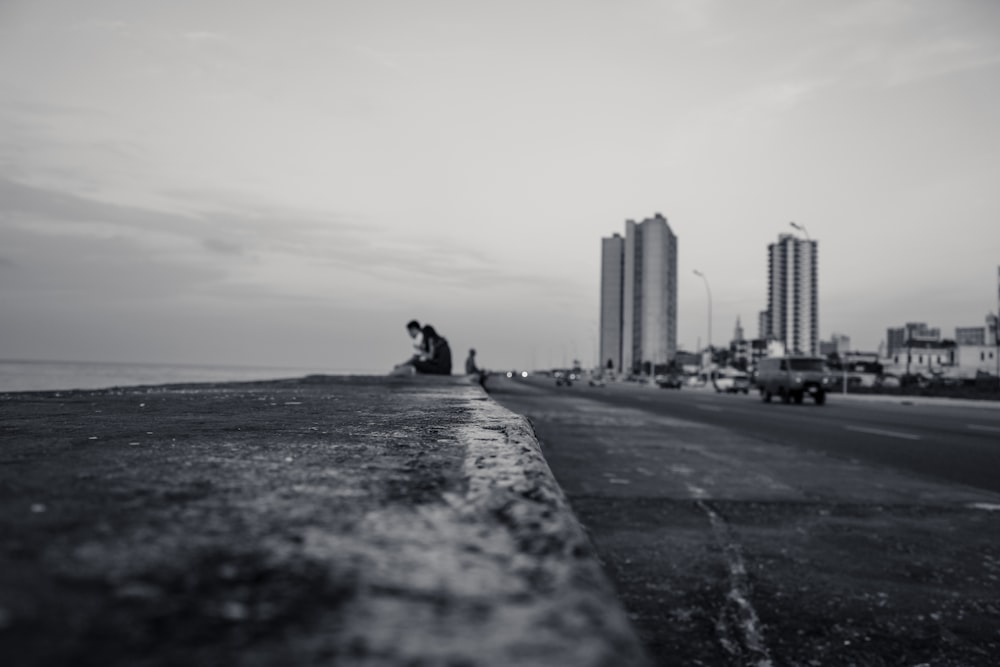 low angle photo of couple sitting near bodies of water