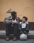 man holding boy's head