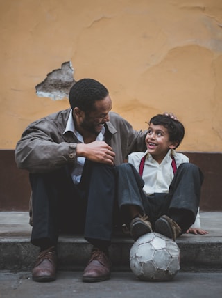 man holding boy's head