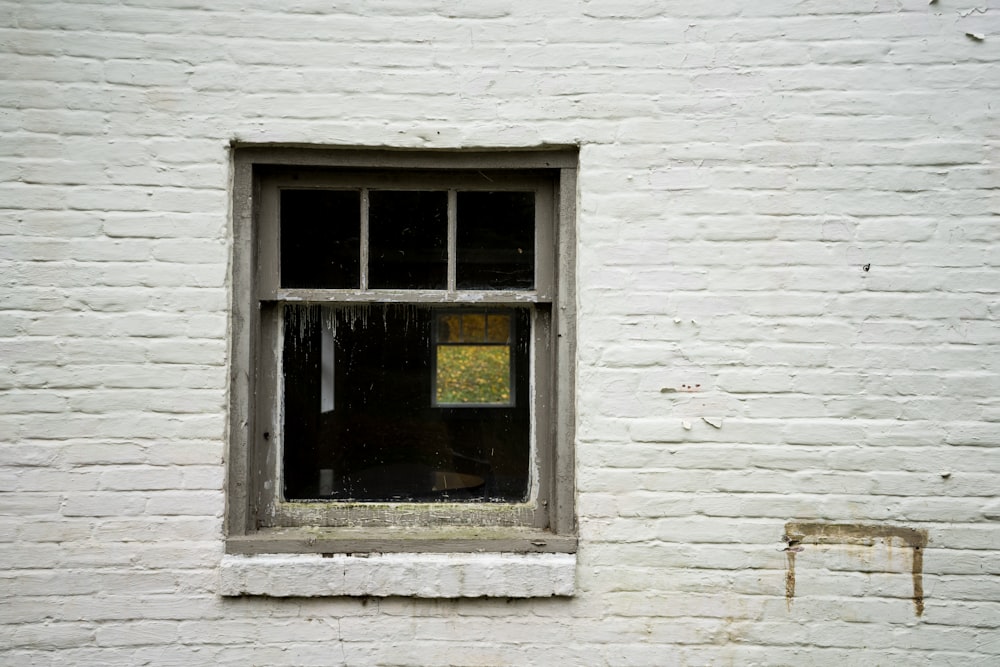 a white brick building with a small window