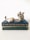gray and white rabbit figurine on green book